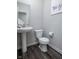 Modern half bathroom featuring a pedestal sink, toilet, and gray walls at 14110 Bay Willow Dr, Fishers, IN 46037