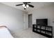 Carpeted bedroom features a ceiling fan, closet, and tv on a black shelf at 14110 Bay Willow Dr, Fishers, IN 46037