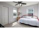 Cozy bedroom with a ceiling fan, carpeted floor, and plenty of natural light from two windows at 14110 Bay Willow Dr, Fishers, IN 46037