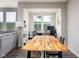 Dining area with large wood table, desk, and ample natural light, adjacent to the living room at 14110 Bay Willow Dr, Fishers, IN 46037