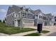 A row of homes featuring a two-car garage and manicured lawns at 14110 Bay Willow Dr, Fishers, IN 46037