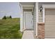 Inviting front entrance features a white door, classic light fixture, and brick accents at 14110 Bay Willow Dr, Fishers, IN 46037