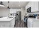 Modern kitchen with stainless steel appliances, a central island, and white cabinets at 14110 Bay Willow Dr, Fishers, IN 46037