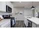 Bright kitchen featuring a gas range, subway tile backsplash and modern black pendant lighting at 14110 Bay Willow Dr, Fishers, IN 46037