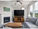 Bright living room with a fireplace, wooden TV stand, and large windows offering great views at 14110 Bay Willow Dr, Fishers, IN 46037