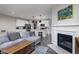Open-concept view of living room and kitchen with fireplace, modern decor, and ample seating at 14110 Bay Willow Dr, Fishers, IN 46037