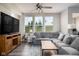 Spacious living room featuring a large sectional sofa, ceiling fan, and big screen television at 14110 Bay Willow Dr, Fishers, IN 46037