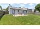 This backyard has a patio with seating, a well-maintained lawn, a wooden fence, and string lights at 14255 Holly Berry Cir, Fishers, IN 46038