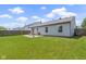 This backyard has a patio with seating, a well-maintained lawn, a wooden fence, and a gray house with black trim at 14255 Holly Berry Cir, Fishers, IN 46038