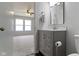 Bathroom showing a gray vanity with a mirror, leading to a view of a bedroom at 14255 Holly Berry Cir, Fishers, IN 46038