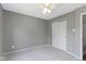 This bedroom has neutral gray walls, gray carpet, a fan, and a closet with sliding white doors at 14255 Holly Berry Cir, Fishers, IN 46038