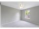 Empty bedroom with gray carpet features a ceiling fan and a window at 14255 Holly Berry Cir, Fishers, IN 46038