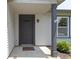 A covered front door with a welcome mat and adjacent window and landscaping at 14255 Holly Berry Cir, Fishers, IN 46038