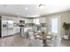 A well-lit kitchen with stainless steel appliances, an island, and adjacent dining area at 14255 Holly Berry Cir, Fishers, IN 46038