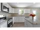 Bright white kitchen boasts stainless appliances, granite countertops, and a convenient island at 14255 Holly Berry Cir, Fishers, IN 46038