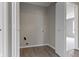 This laundry room has light gray walls, wood-look floors, and a washing machine and dryer hookup at 14255 Holly Berry Cir, Fishers, IN 46038