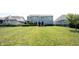 Expansive backyard view highlights a stone patio with a fire pit, surrounded by a well-maintained lawn at 14982 Dawnhaven Dr, Westfield, IN 46074