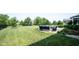 Spacious backyard featuring a fire pit seating area, set against a backdrop of lush green lawn and trees at 14982 Dawnhaven Dr, Westfield, IN 46074
