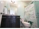 A stylish bathroom featuring a dark vanity, granite countertop, and decorative shower curtain at 14982 Dawnhaven Dr, Westfield, IN 46074