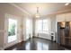 Dining area with hardwood floors, modern chandelier, backyard access, and stainless steel refrigerator at 14982 Dawnhaven Dr, Westfield, IN 46074