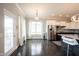 A bright dining area features hardwood floors, white trim, modern lighting, and stainless appliances at 14982 Dawnhaven Dr, Westfield, IN 46074