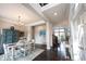 Open-concept dining room with hardwood floors, decorative chandelier, and bright natural light at 14982 Dawnhaven Dr, Westfield, IN 46074