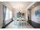 Light-filled dining room features elegant table setting, chandelier, and stylish blue accents at 14982 Dawnhaven Dr, Westfield, IN 46074