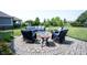 Backyard fire pit with stylish blue-cushioned seating and landscaping, perfect for outdoor gatherings at 14982 Dawnhaven Dr, Westfield, IN 46074