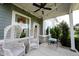 Inviting front porch with stone accents, wicker chairs, and string lights creating a cozy outdoor space at 14982 Dawnhaven Dr, Westfield, IN 46074