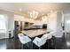 Bright, open kitchen with a large center island, white cabinetry, and modern lighting fixtures at 14982 Dawnhaven Dr, Westfield, IN 46074