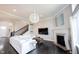 Open concept living room boasts dark hardwood floors, fireplace, and easy access to stairway at 14982 Dawnhaven Dr, Westfield, IN 46074