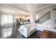 Open living space with modern light fixture and hardwood floors flows to a large eat-in kitchen at 14982 Dawnhaven Dr, Westfield, IN 46074