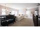Spacious living room with a piano and a comfortable seating area at 14982 Dawnhaven Dr, Westfield, IN 46074