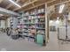 Finished basement featuring gray painted shelves for storage and organization with exposed ceiling and lighting at 1504 Mcclure Rd, Columbus, IN 47201