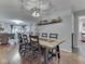Open concept dining area showcasing a long wooden table, hardwood floors, and modern lighting at 1504 Mcclure Rd, Columbus, IN 47201