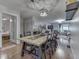 Open-concept dining room boasts modern lighting and an adjacent living room, seamlessly combining style and functionality at 1504 Mcclure Rd, Columbus, IN 47201