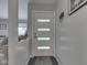 Bright entryway featuring a modern door with frosted glass and a gray accent wall at 1504 Mcclure Rd, Columbus, IN 47201