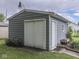 The garage has gray siding and white doors, offering additional storage at 1504 Mcclure Rd, Columbus, IN 47201