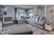 Spacious living room with stylish gray sectional sofa, ottoman, and a large window at 1504 Mcclure Rd, Columbus, IN 47201