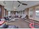 Large brick sunroom with multiple seating areas and ceiling fans at 1504 Mcclure Rd, Columbus, IN 47201