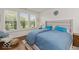 Comfortable bedroom features a plush bed, bright natural light and serene backyard views at 15879 Viking Commander Way, Westfield, IN 46074