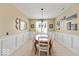 Formal dining room with wainscoting, decorative chandelier, and an elegant oval table at 15879 Viking Commander Way, Westfield, IN 46074