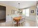 Charming dining area featuring stylish wainscoting, decorative lighting and comfortable seating at 15879 Viking Commander Way, Westfield, IN 46074