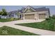 The home has a large three-car garage and a well-maintained lawn and landscaping at 15879 Viking Commander Way, Westfield, IN 46074