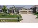Charming home with a three-car garage, well-manicured lawn, and inviting front porch at 15879 Viking Commander Way, Westfield, IN 46074