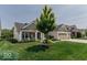 Beautiful home with lush green lawn, mature landscaping, and a three-car garage at 15879 Viking Commander Way, Westfield, IN 46074