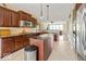 This gourmet kitchen features stainless appliances, an island and a view into other rooms at 15879 Viking Commander Way, Westfield, IN 46074