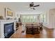 Bright living room with fireplace, hardwood floors, and large windows offering plenty of light at 15879 Viking Commander Way, Westfield, IN 46074