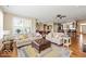Inviting living room with hardwood floors, comfortable seating, and an open view to the kitchen at 15879 Viking Commander Way, Westfield, IN 46074