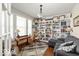 Well-lit home office with built-in shelving, desk area, and comfortable seating at 15879 Viking Commander Way, Westfield, IN 46074